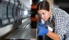 Young,Female,Worker,In,Plaid,Shirt,And,Gloves,Operating,Press